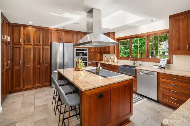 Custom cabinetry, tons of storage, pantry with pull-outs + induction cooking