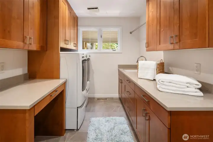 Large remodeled laundry room with utility sink