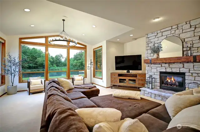 Stunning living room with floor to ceiling windows which capture your private lake!