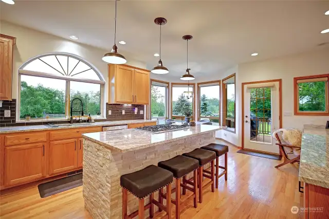 Updated kitchen with granite countertops, stone island, and endless amazing views!