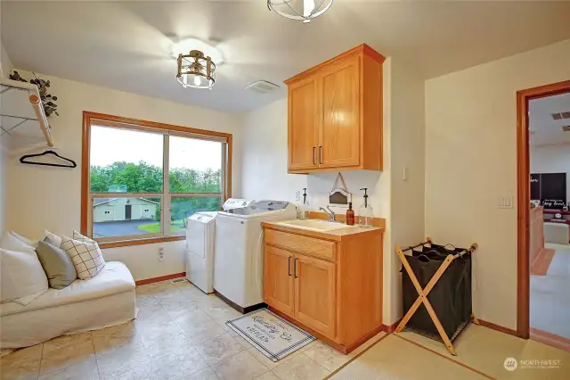 Upstairs 2nd laundry/utility room with an amazing view of Barn, Equestrian Arena, fruit trees, and more!
