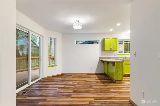 Dining area attached to kitchen opens up to large trex deck