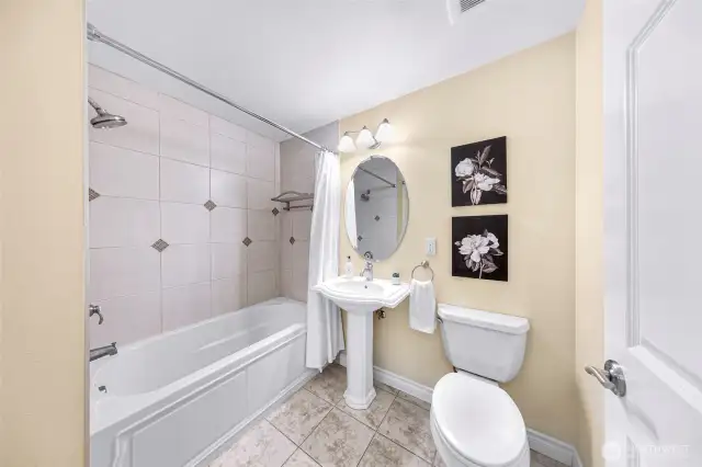 Full guest bath off living space with extra deep soaking tub