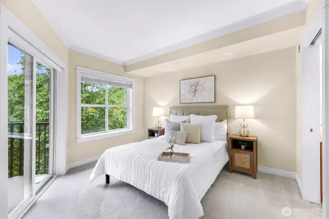 Light and bright primary bedroom with sliding door balcony access