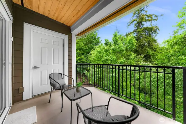 Private balcony overlooking the tree canopy and trails below, serene and secluded feeling. Storage & hot water heater, radiant floor heating located in balcony storage.