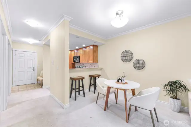 View from laundry in living space to dining, kitchen and main entry