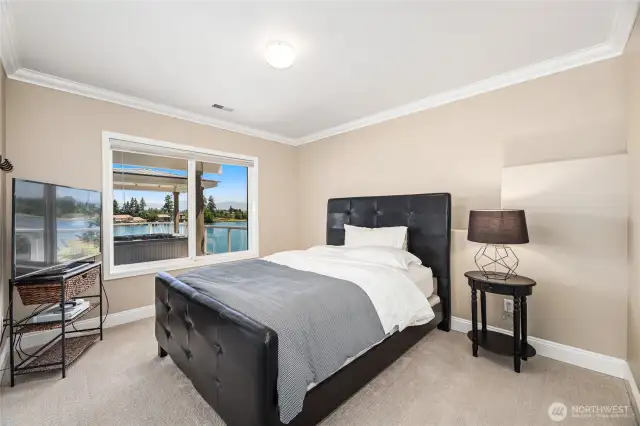 Lower level bedroom with views of the lake and hot tub.