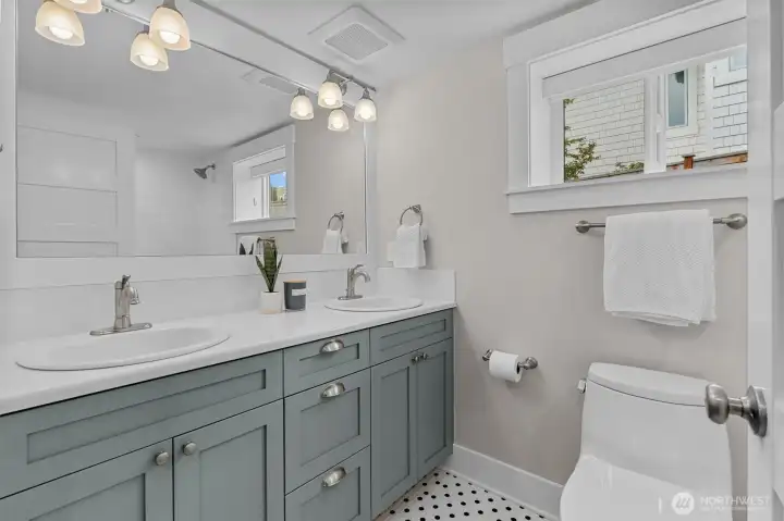 The lower-level bathroom showcases thoughtful details and stylish touches, including modern fixtures, elegant tile work, and a clean, bright design.