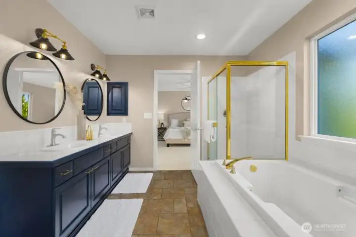 Ensuite bath with double vanity, soaking tub, separate shower, and modern lighting.