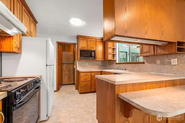 Kitchen flows into laundry room, additional pantry space and Breakfast Bar