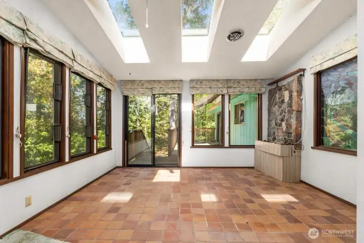 Delightful sunroom located off of the primary suite and deck.