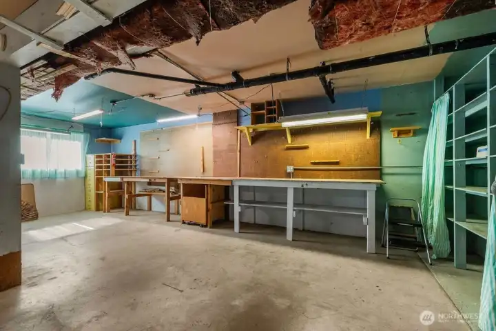 Large two car garage with ample storage and workbench. New hot water heater installed 2018.