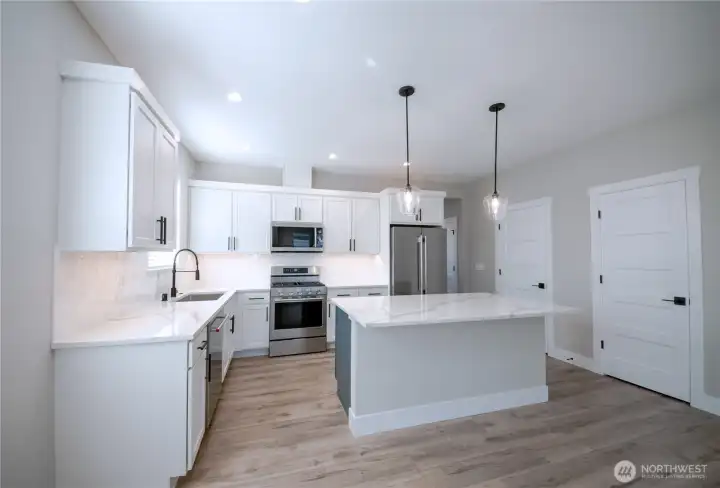 Upgraded appliances, classic white hexagon artisan tile and a blue island for a subtle pop.