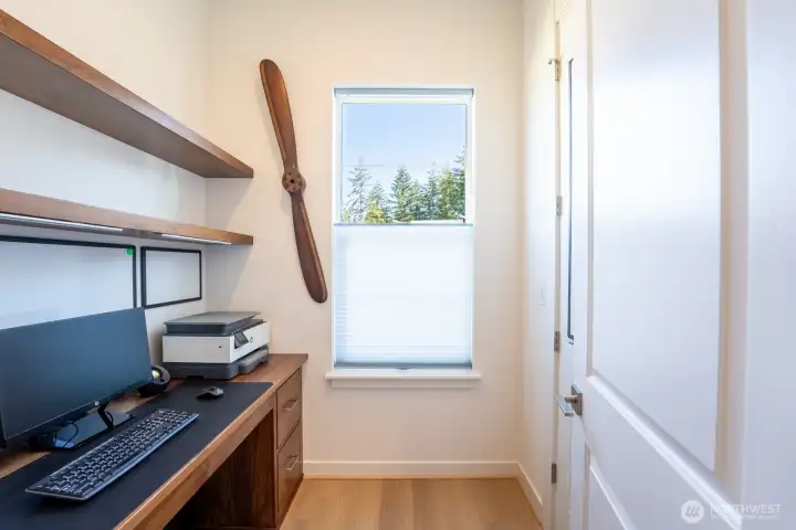 Custom desk and shelving create a great space for work or screen time.