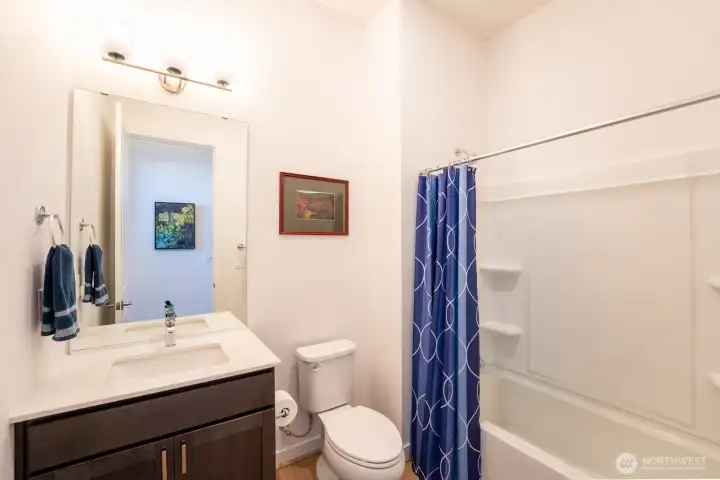 Full guest bath located near the entry and second bedroom.
