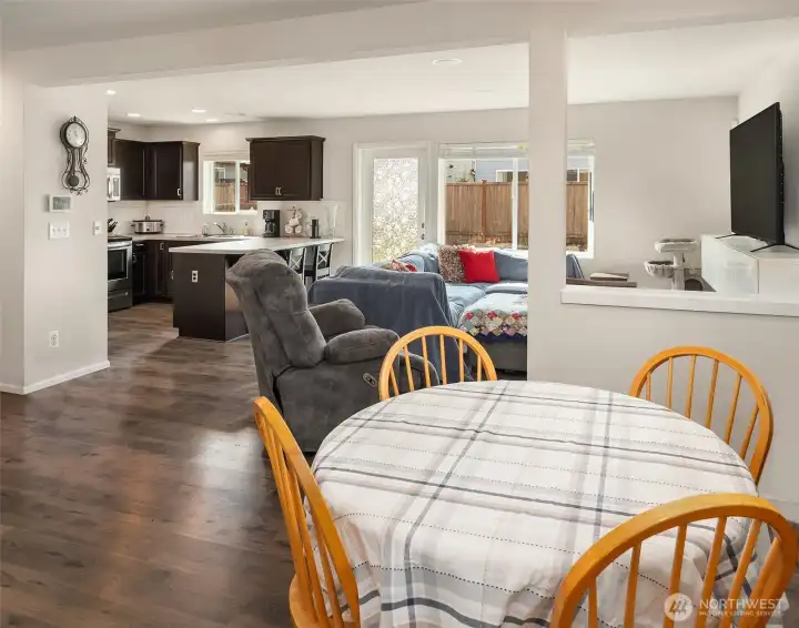 Dining area with kitchen and living room in background