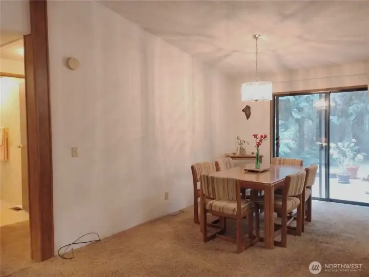 The dining room has vaulted ceiling and is open to the kitchen on the right side of this photo. The dining room has vaulted ceiling and is open to the kitchen on the right side of this photo.