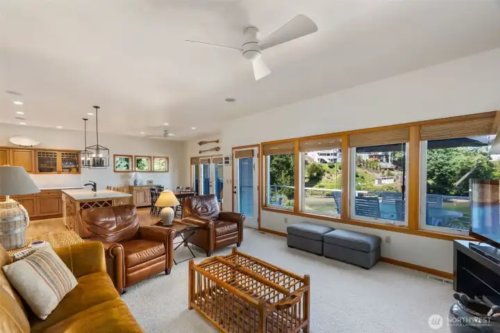 The welcoming living room has a bank of large windows to bring in light and the views.