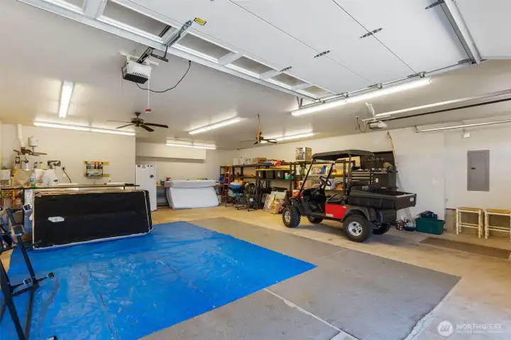 Huge garage with laundry, large laundry sink, plenty of space for vehicles and a workshop. The floor features radiant heating to keep you cozy while puttering. 3/4 bath in this space, and ceiling fans for true convenience and comfort.