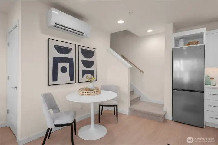 Tucked behind the stairs, additional storage for a clutter free living, eating, and dining space