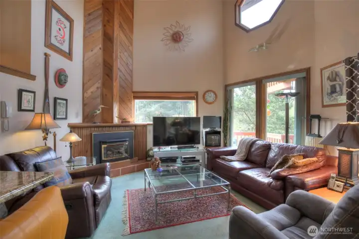 Cathedral ceilings, windows throughout and immaculate cedar woodwork surronding propane fireplace.