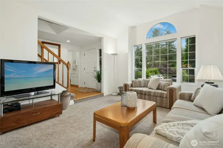 Formal living room with tall, coved ceiling and beautiful windows.