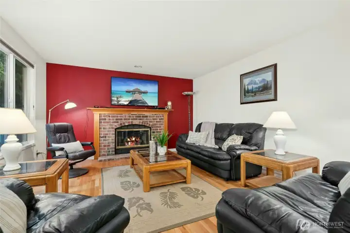 Family room with a gas fireplace and hardwood floors.