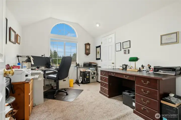 Another guest room with a tall, coved ceiling and beautiful windows. Currently being used as an office space.