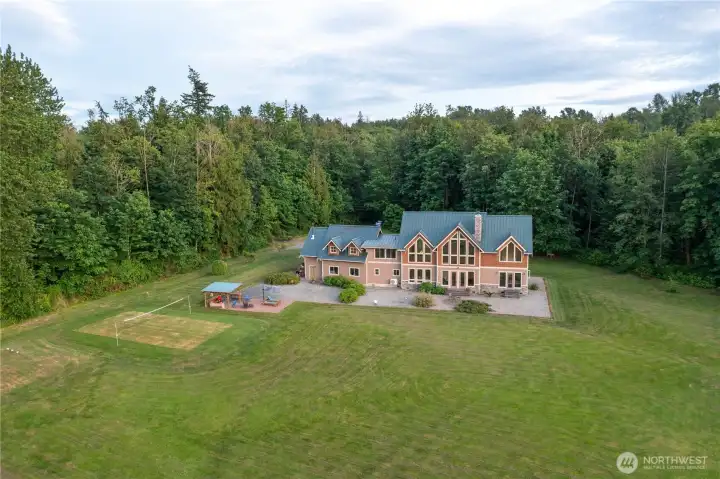 Large finished backyard in private forested setting.