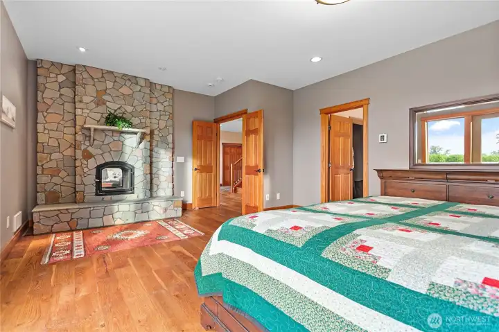 Primary with stone wood fireplace.
