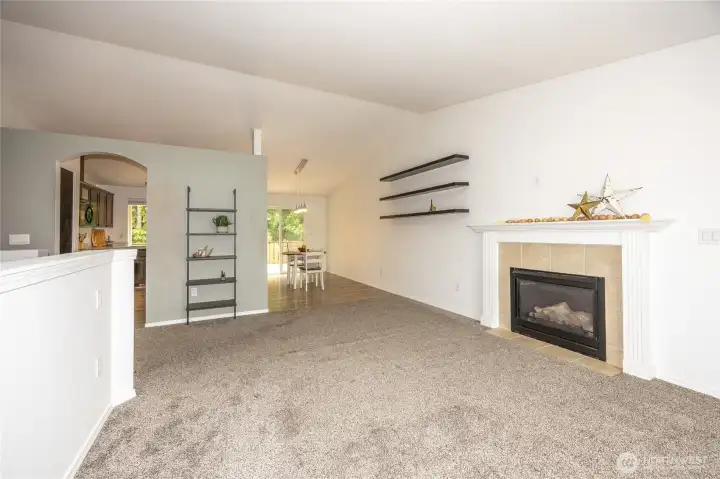 Propane fireplace off the living room with floating shelves ready for your creative styling