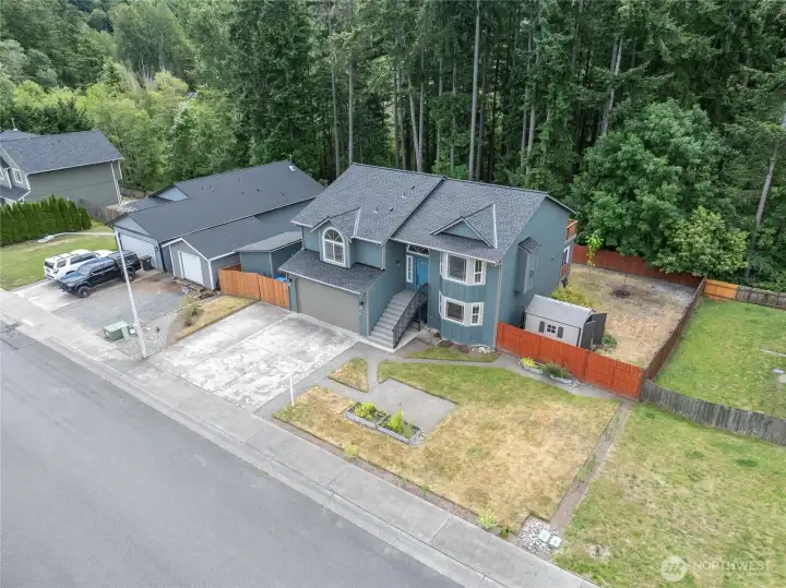Fully fenced back yard, storage sheds, firepit, patio, and back deck await your summer!