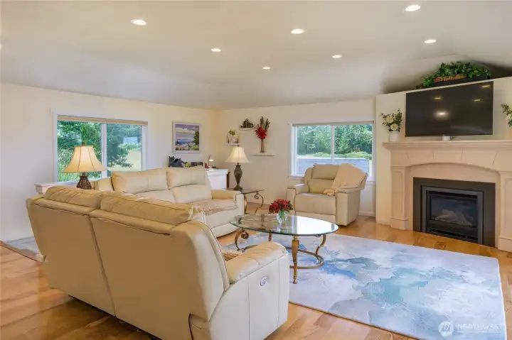Living room has propane fireplace and desk nook in the far corner.