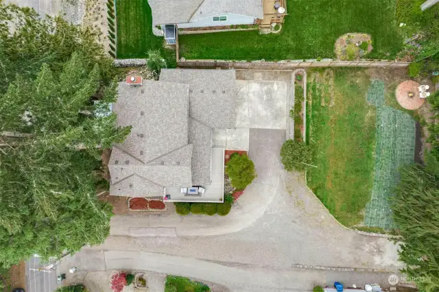 A lovely and relatively flat landscaped yard and large driveway!