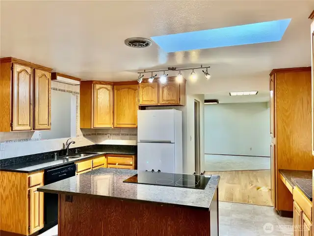 Kitchen island with beautiful granite and a skylight for added light.