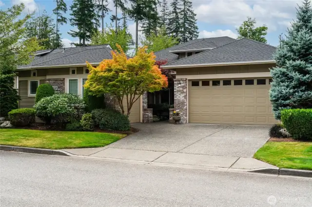 Sought after Hemlock floor plan with clean architectural lines and brick accents, garden walkway leading to covered front porch and mature landscaping
