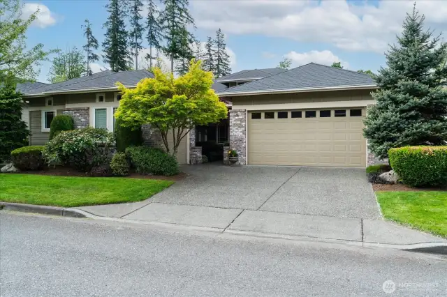 Sought after Hemlock floor plan with clean architectural lines and brick accents, garden walkway leading to covered front porch and mature landscaping