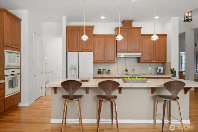 Elongated kitchen island provides an ideal place for quick meals or serving buffet style