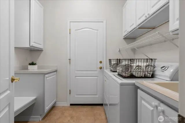 Laundry/mud room provides additional storage, built-in sink and acts as segue between garage and kitchen