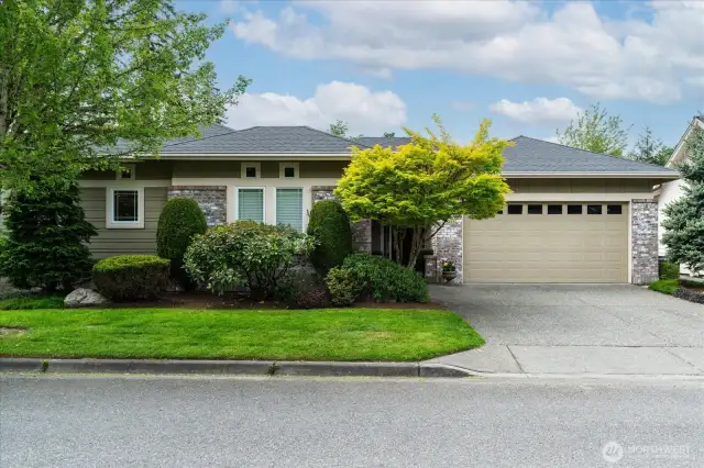 Sought after Hemlock floor plan with clean architectural lines and brick accents, garden walkway leading to covered front porch and mature landscaping