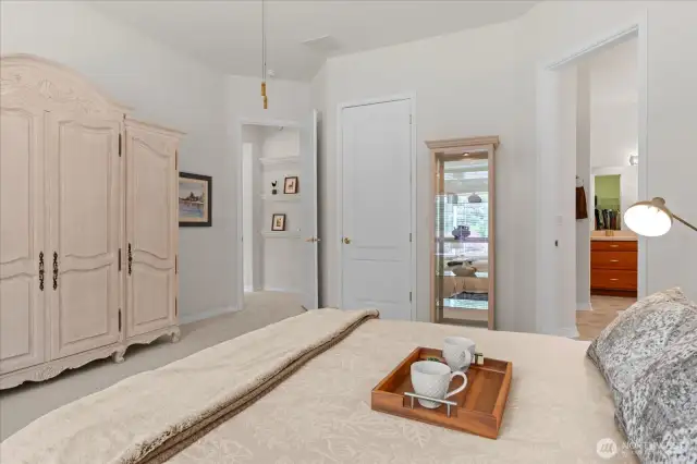 Plenty of room for a king-sized bed and armoire or dresser in this nicely sized primary suite offering two walk-in closets