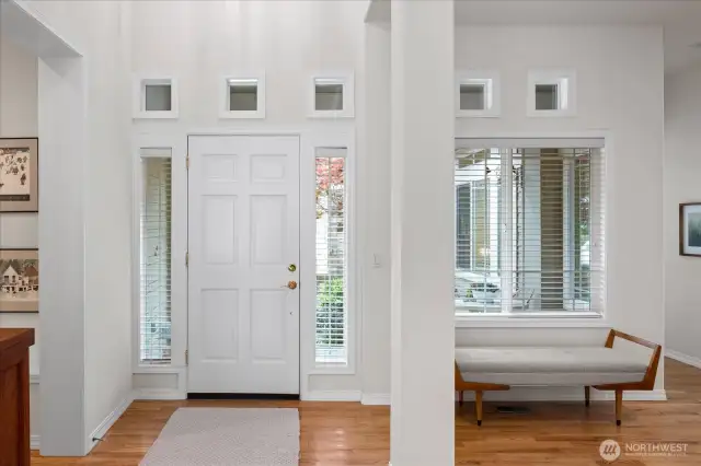 Impressive entrance with two story ceilings and warm, rich hardwood flooring