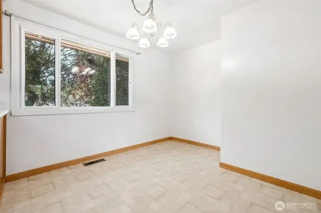 Here's a close up view of the dining space with a bump out for a sideboard or hutch, and a sizeable window looking out to the backyard.