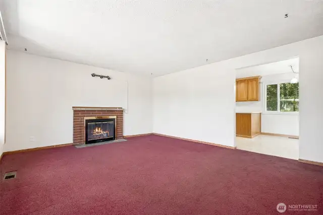 As you enter the home you come into the living room with a gas fireplace. Also, there are HARDWOODS under the carpet!