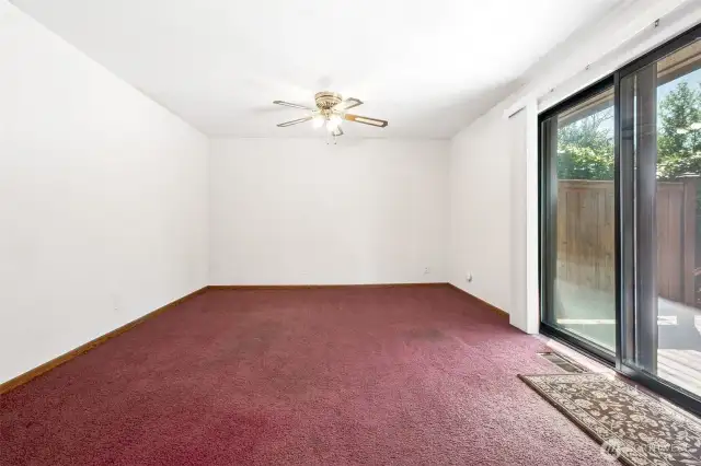 This is the spacious family room with slider to the deck and ceiling fan.