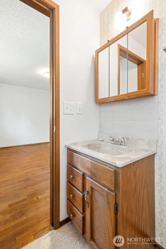 Primary half-bath with pocket door.
