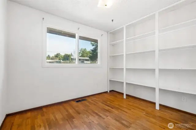 Bedroom #3 with built in storage, large closet and window.