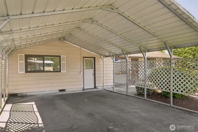 A closer look at the nice sized carport. There's an entrance here that leads to a large bedroom, and 3/4 bath - possible multi-generational living.