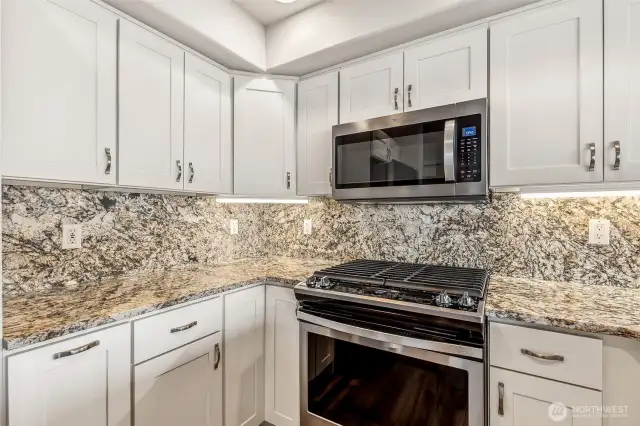Gas cooktop, shaker cabinets, granite  backsplash & countertops....very nice set up!