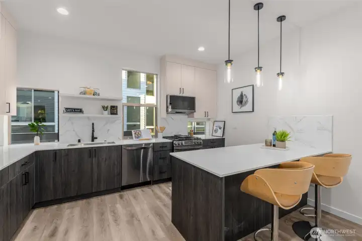 Photos of Model Home. Chef’s kitchen designed for both beauty and function, with sleek cabinetry, quartz countertops, and generous workspace for culinary creativity.